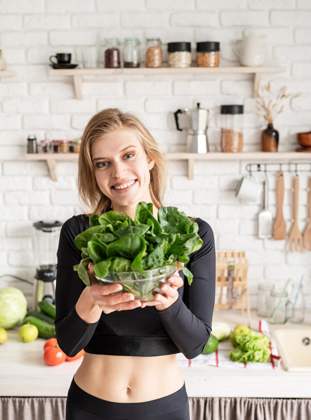 healthy-eating-diet-and-cooking-concept-young-blond-smiling-woman-holding-a-bowl-of-fresh-spinach.jpg